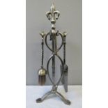 A wrought iron fire guard decorated with fleur-de-lys 64 by 84cm, together with matching four