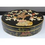A Chinoiserie black lacquered circular box inset with tree of life, the peaches in agate.
