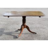 A mahogany tilt top centre table with tripod base.