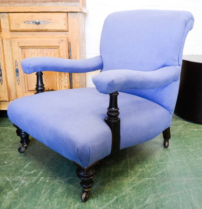 An armchair upholstered in blue.