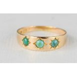 A 15ct gold and turquoise ring, set with three turquoise roundels, size P, 1.9g.