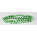 A green hardstone beaded necklace.