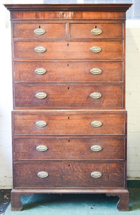 A 19th century mahogany chest on chest, with crossbanding and oval brass handles, raised on