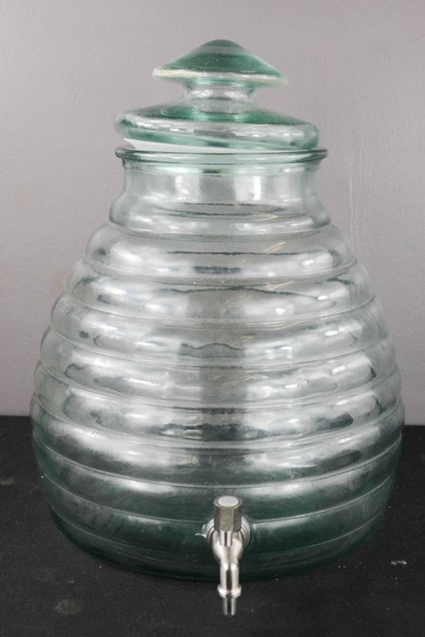 A glass drinks dispenser, of beehive form.