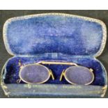 A pair of Victorian pince nez spectacles, in a leather case.
