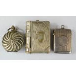 A silver vesta case with match striker to the base, a coin holder locket, and a further vesta case.