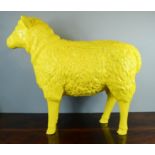 A model life size sheep in yellow.
