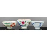 Three Chinese rice bowls, two early 19th century enamelled with decoration and the other in blue and