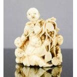 A Chinese 19th century carved netsuke figure group, 5cm high.