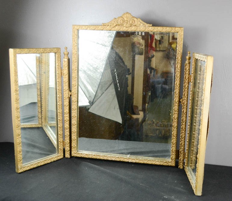 A gold painted triptych mirror.