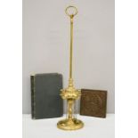 A 19th century brass whale burner, Victorian cast iron tile / kettle stand, together with a book