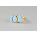 A 9ct gold and opal ring, the three oval opals set in a row, size O, 3.7g.