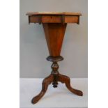 A 19th century walnut and mahogany work box, with blue silk lined interior, raised on a tripod base.