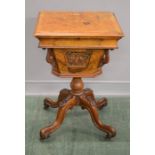 A William IV walnut work table, with a carved decorative base, inlaid top, and fitted interior.