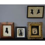 A group of four silhouette Victorian portraits.