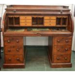 A Victorian mahogany roll top bureau, the fitted interior composed of satinwood veneered drawers,