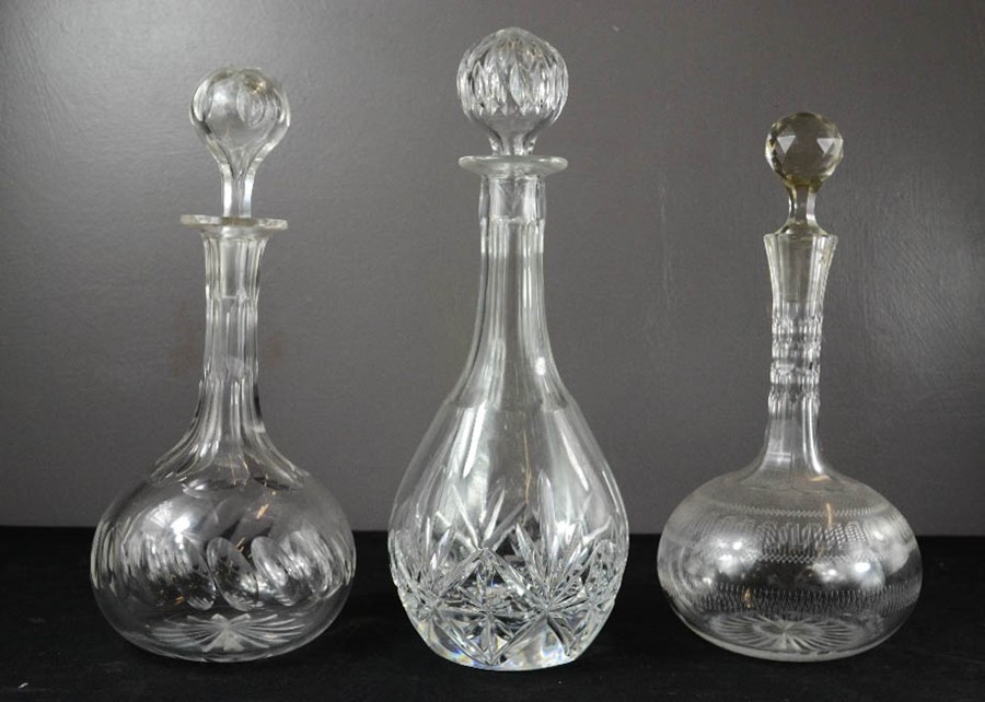 Three cut glass and crystal decanters of differing style and form.