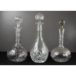 Three cut glass and crystal decanters of differing style and form.