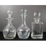 Three cut glass and crystal decanters, differing style and form.