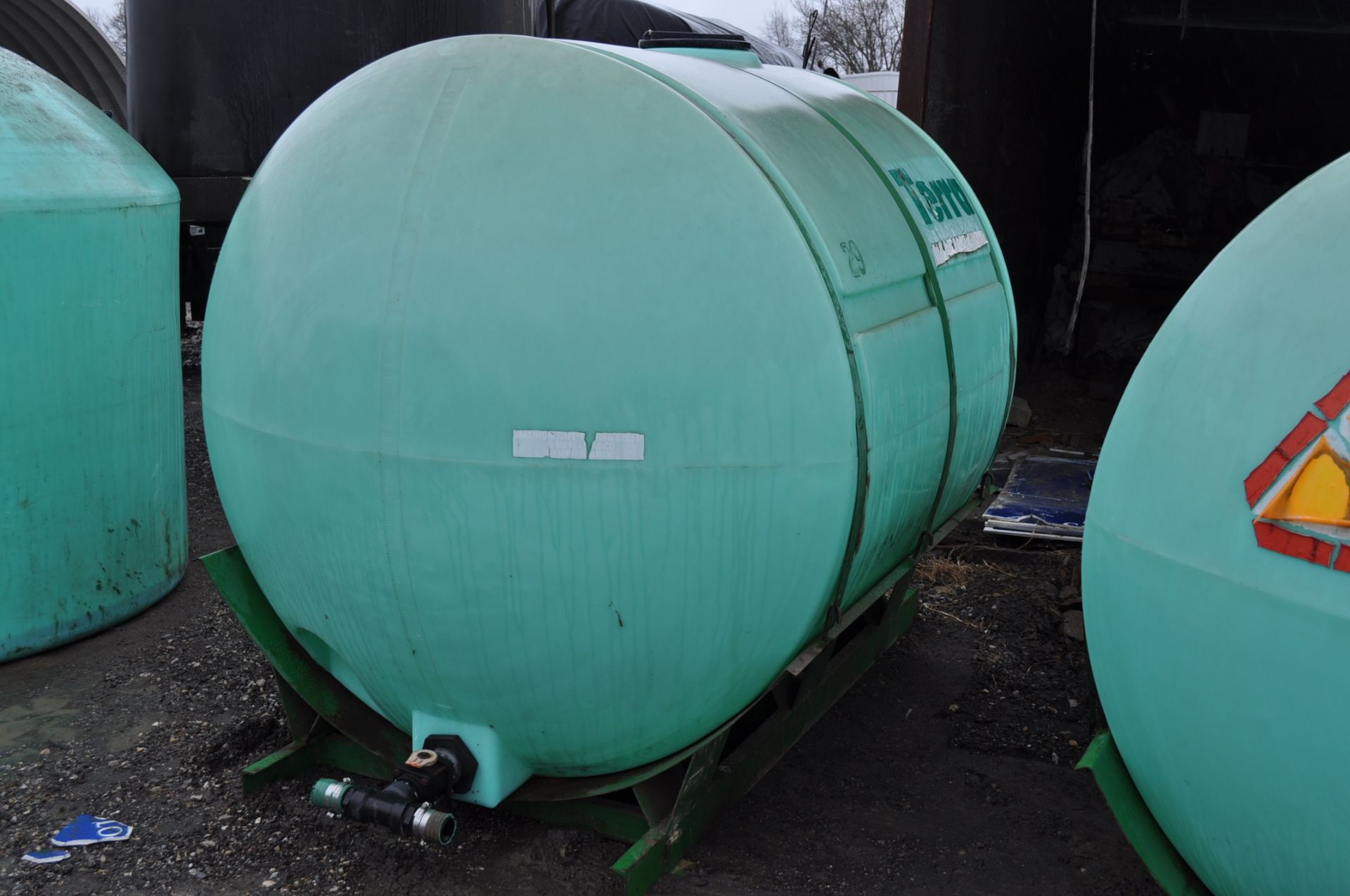 1000 gal poly round tanks on metal skids