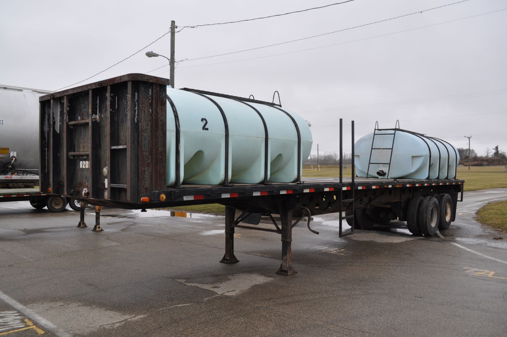 1982 Transcraft 40’ flat trailer with 2-2000gl poly tanks