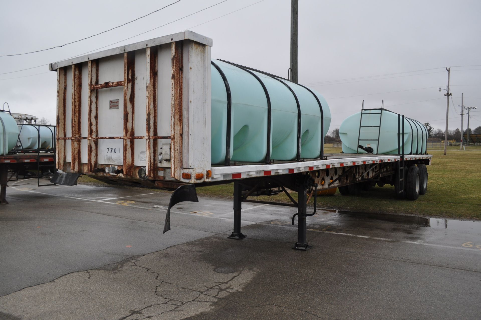 1977 Transcraft 42’ flat trailer with 2-2000gl poly tanks