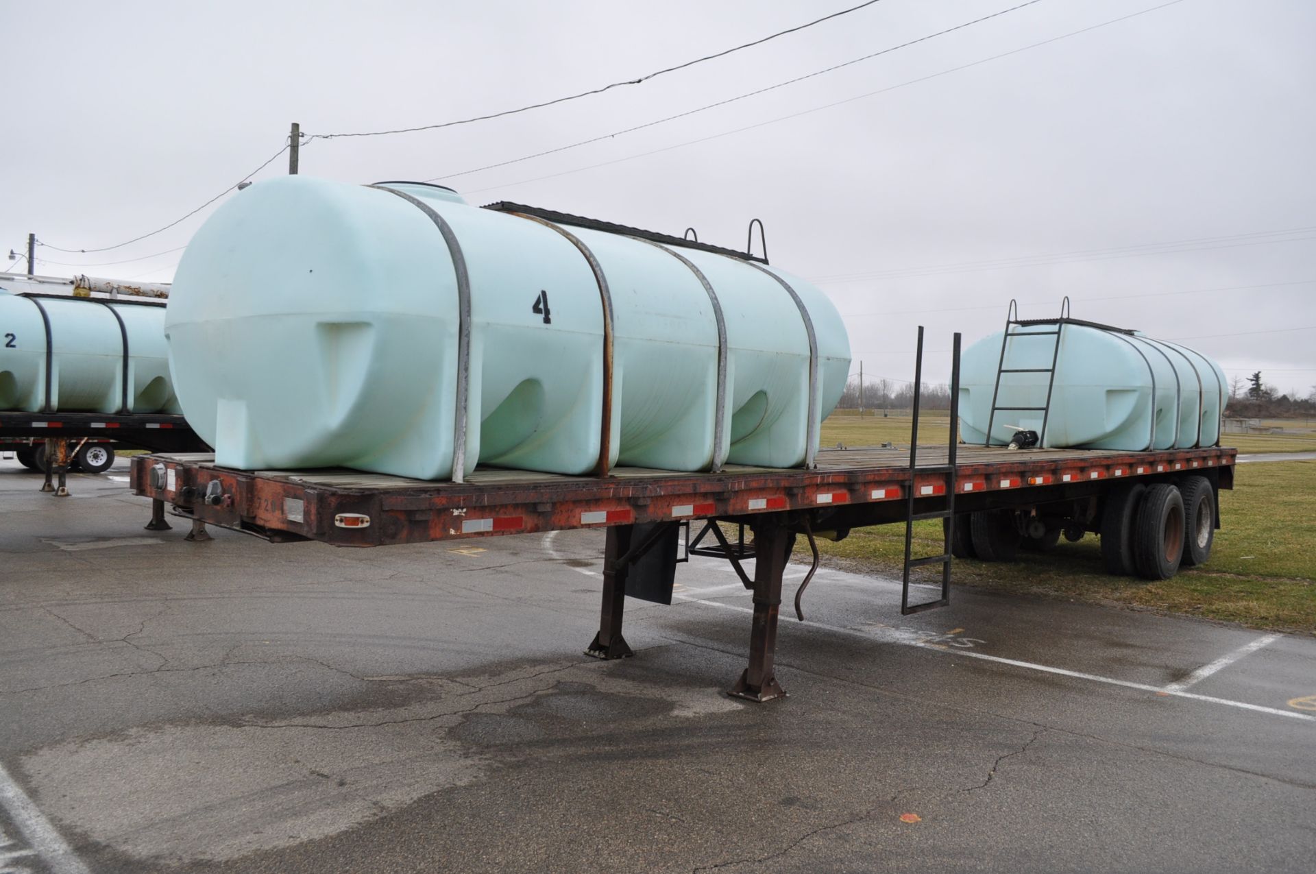 1972 Clark Equip 40’ flat trailer with 2-2000gl poly tanks