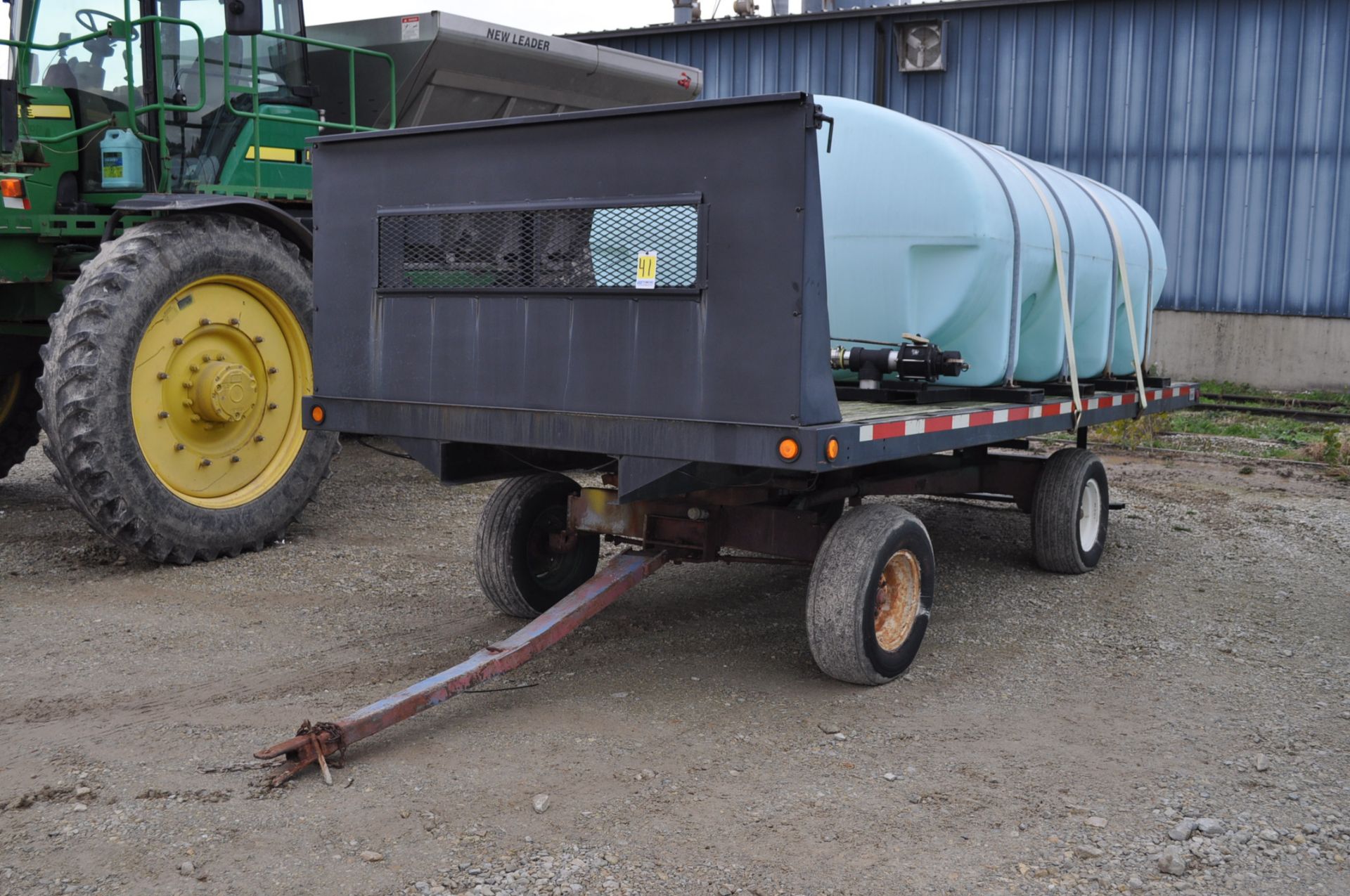 2,000-gal horizontal leg tank w/ bands, mounted on 18’ Rugby flatbed w/ headache rack