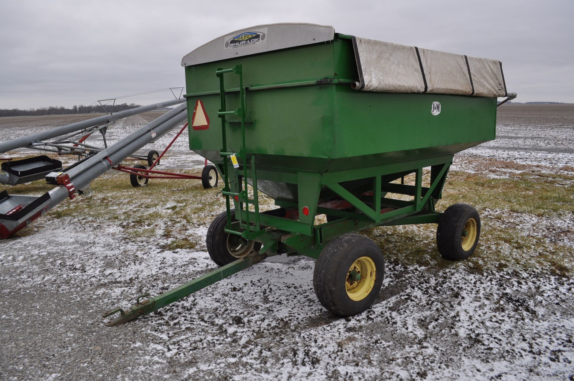 J&M 250 bu gravity bed wagon on running gear,