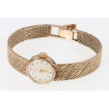 9ct gold ladies Longines wristwatch on a 9ct gold woven strap. 27.