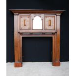 Oak fire surround, the projected moulded cornice over a central mirror, panels and shelves,