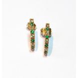 Pair of diamond and emerald earrings of comma shape.