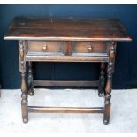 1920s oak side table with single drawer raised on turned legs united by stretchers,