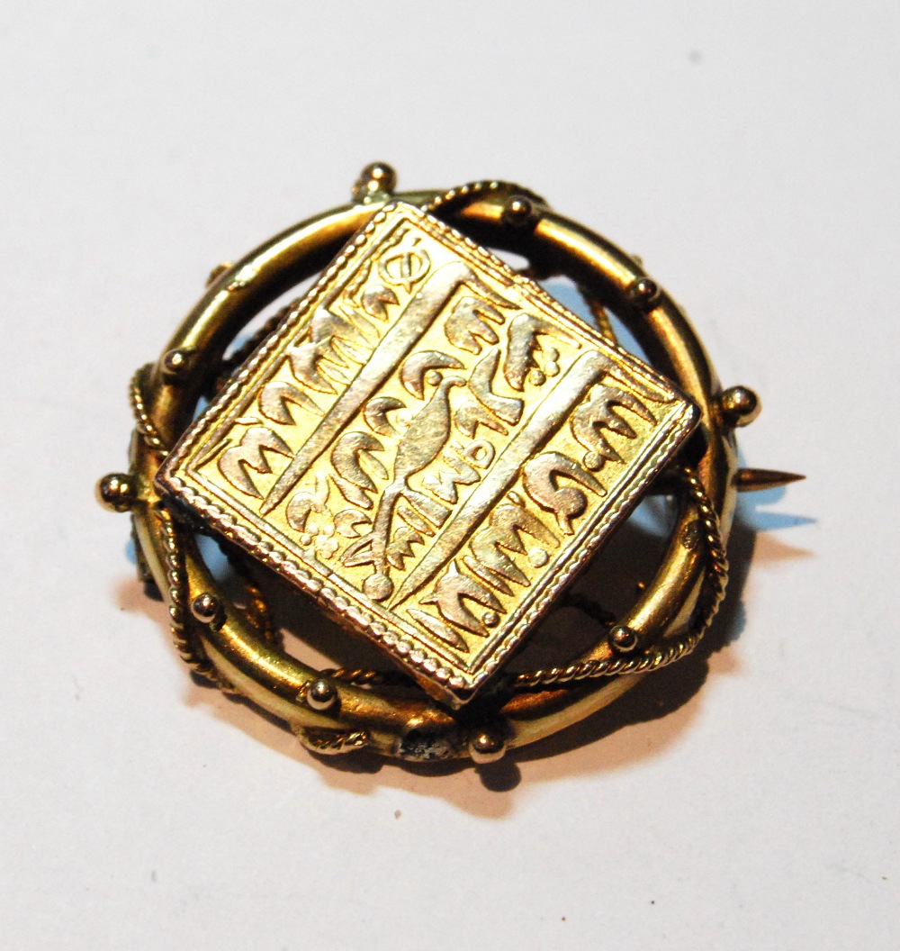 Indian gold square coin, mounted in a circular brooch.