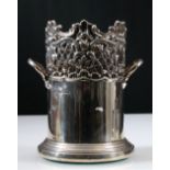 Edwardian silver tall decanter stand with pierced embossed upper part and loop handles, wood base,