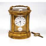 Mid 19th century repeater carriage clock of oval form mounted by a handle with etched decoration,