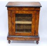 Victorian walnut cabinet of miniature proportions, the moulded rectangular top over a glazed door,