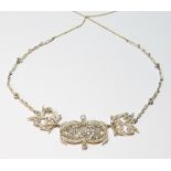 Diamond necklace of late Victorian style with an openwork arrangement of various collet-set