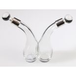 Glass conjoined oil and vinegar bottles with collar and ball stoppers, 1909.