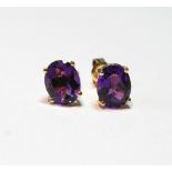 Pair of ear studs, each with an oval amethyst in 14ct gold.