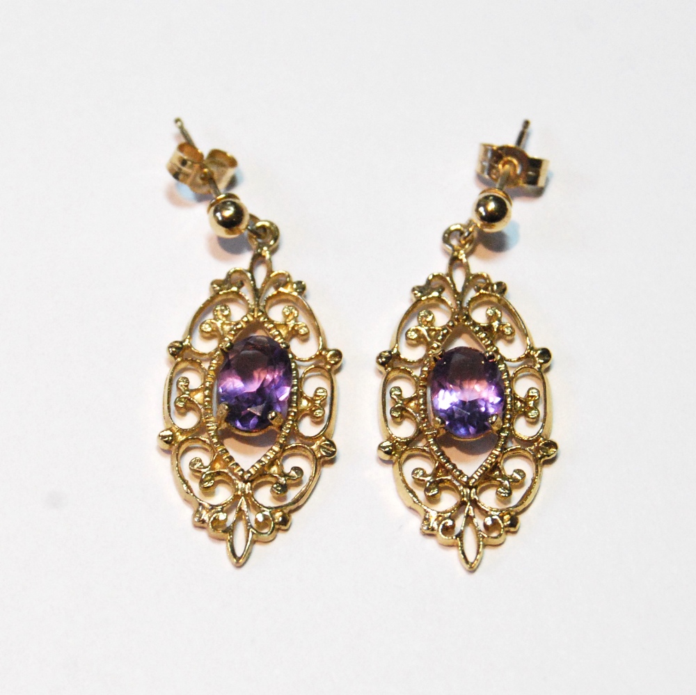 Pair of 9ct gold drop earrings, each with an amethyst in gold scrolls.