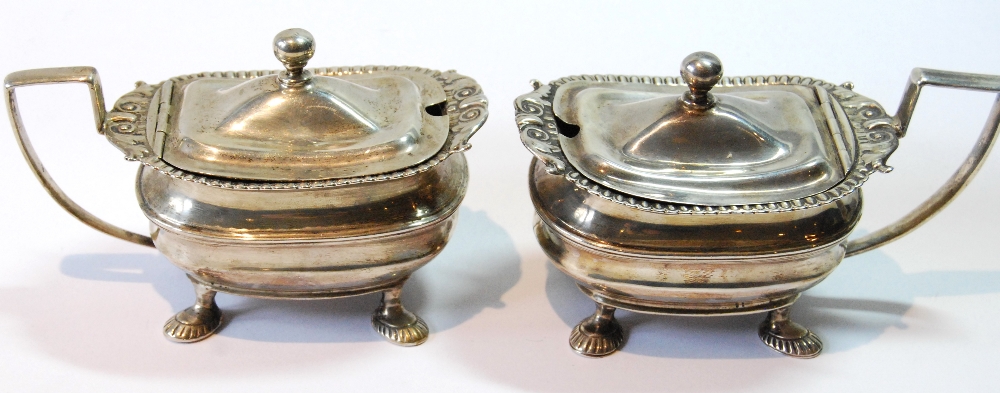 Pair of silver mustard pots of Regency style, rectangular, upon scalloped feet, Nathan & Hayes,