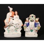 Staffordshire flatback figure group of a seated couple with clock face beneath and another of a