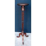 Mahogany torchere, the circular top raised on cluster columns and tripod cabriole supports,