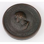 Bronze embossed circular box commemorating Lord Nelson enclosing seven circular prints depicting