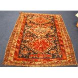 Persian rug with triple tree and dog tooth diamonds on blue ground with triple border,