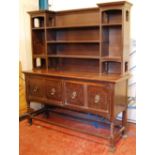 Oak dresser with moulded cornice and open shelves over moulded rectangular top,