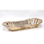 Old Sheffield plated bread dish of boat shape with moulded, scalloped and scroll border, c.