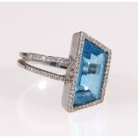Dress ring with trapezoid blue spinel with woven and double shank with tiny brilliants in white