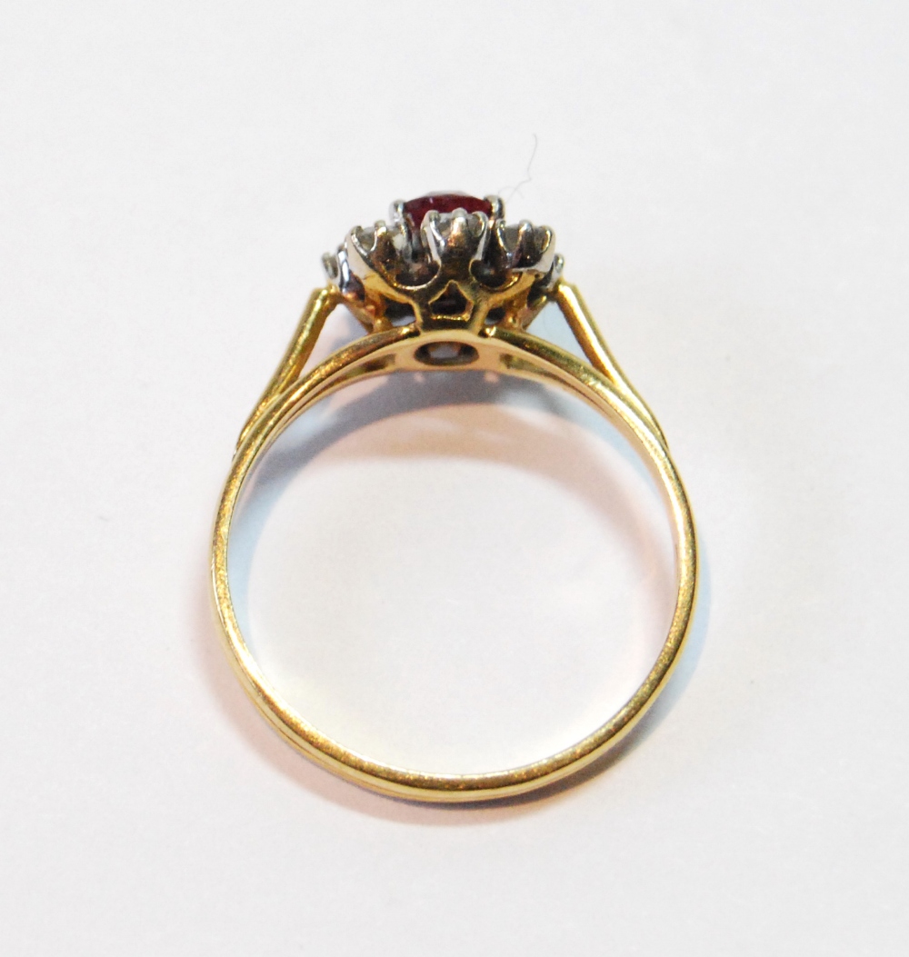 Diamond and ruby oval cluster ring in 18ct gold, 1977, size M. - Image 2 of 3